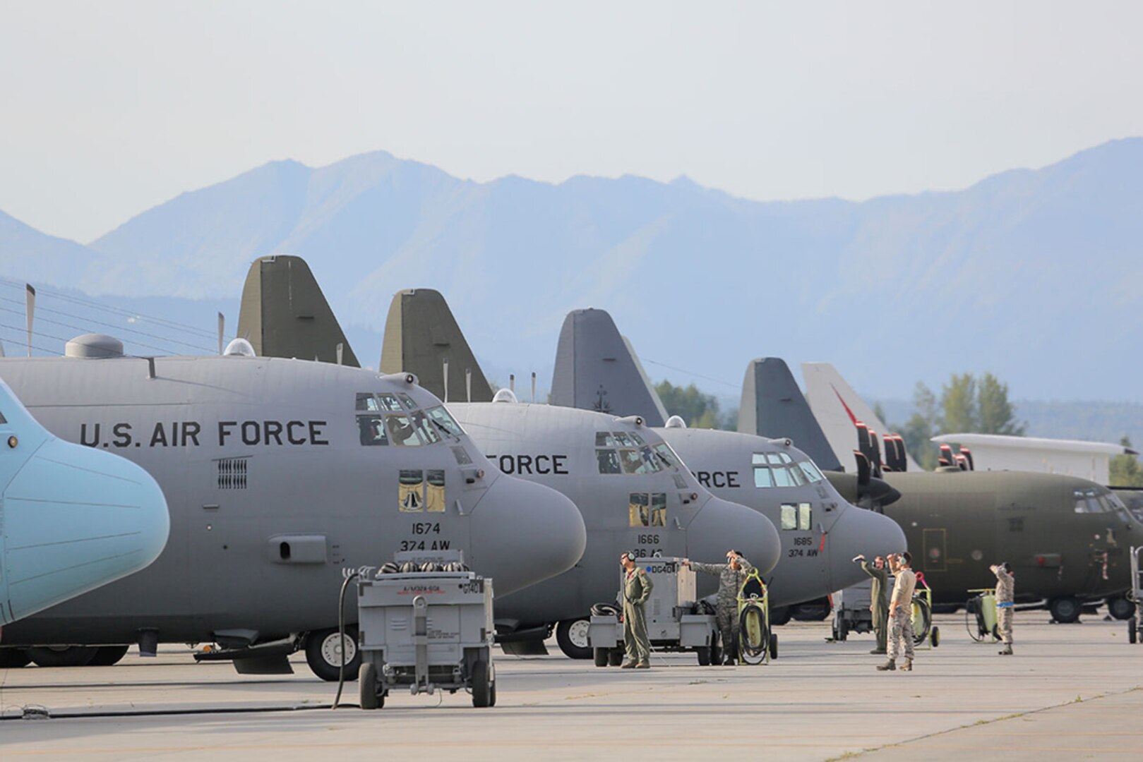 In this photo, U.S. Air Force C-130 Hercules aircraft maintainers assigned to the 36th Airlift Squadron out of Yokota Air Base Japan, observe a departing F-22 Raptor on Joint Base Elmendorf-Richardson Aug. 14. JBER is hosting Red Flag-Alaska, a series of Pacific Air Forces training exercises for U.S. and international forces to provide joint offensive, counter-air, interdiction, close air support, and large-force employment in a simulated combat environment. 