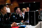 In this photo, participants of the command post exercise portion of the Pacific Airlift Rally gather for an opening speech on Joint Base Elmendorf-Richardson, Aug. 25. The Pacific Airlift Rally is a bi-annual, multinational military-airlift symposium for nations in the Indo-Pacific Region and is hosted by the Pacific Air Forces. 