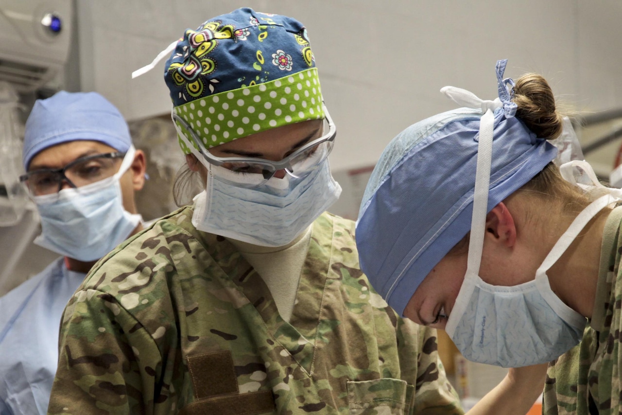 U.S. Army First Lt. Suzzane Laux, center, watches as U.S. Army Sgt. Sarah Fehlberg, right, prepares a wounded Afghan national policeman for emergency surgery on Forward Operating Base Farah, Afghanistan, Nov. 20, 2012. Laux, an operating room nurse, and Fehlberg, an advanced trauma life support medic, are assigned to the 541st Forward Surgical Team. U.S. Navy photo by Chief Petty Officer Josh Ives