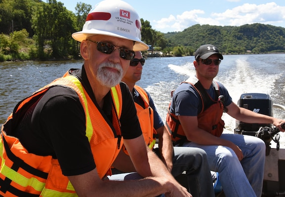 Resident engineer Scott Baker, center, during the weekly progress meeting and site visit  Aug. 11, 2015, for the Harper’s Slough project. The Harper’s Slough Habitat Rehabilitation and Enhancement Project, located within the Upper Mississippi River National Wildlife and Fish Refuge, was planned and designed under the authority of the Upper Mississippi River Restoration Program. It will protect five existing islands and construct an additional seven islands using material from the backwater and main channel. The program emphasizes habitat rehabilitation and enhancement projects and long-term resource monitoring. Project component includes dredging backwater areas and channels, constructing dikes, creating and stabilizing islands and controlling side channel flows and water levels. Once the project is completed, the project will be turned over to the U.S. Fish and Wildlife Service, who manages the refuge.