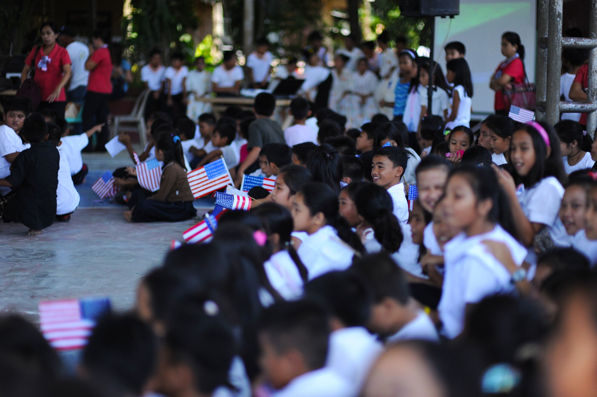 Students from Dao Elementary school attend the closing ceremony of Pacific Angel Philippines 15-1 in Bohol Provence, Philippines, Aug. 24, 2015. Over the course of six days, 5,101 patients received health care and six different schools were refurbished providing rehabilitated learning space to approximately 5,000 students, in addition approximately 10 subject matter expert exchanges occurred on topics ranging from crowd control to mass casualty events to public health outreach.  Efforts undertaken during Pacific Angel help multilateral militaries in the Pacific improve and build relationships across a wide spectrum of civic operations, which bolsters each nation’s capacity to respond and support future humanitarian assistance and disaster relief operations. (U.S. Air Force photo by Tech. Sgt. Aaron Oelrich)