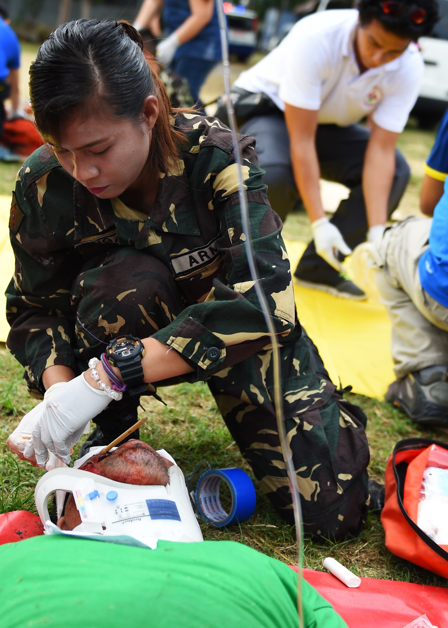 A member of the Philippine army prepares a patient with simulated injuries for emergency transportation during a mass-casualty exercise as part of Pacific Angel Philippines, Bohol Province, Philippines, Aug. 21, 2015. The mass-casualty exercise was the culminating event of a five-day subject matter expert exchange between the U.S. Defense Institute for Medical Operations, the Armed Forces of the Philippines, the Philippine National Police, the Telephone and Radio System Integrated Emergency Response, the Provincial Heath Care Unit and the City Heath Care Unit. Pacific Angel is a multilateral humanitarian assistance civil military operation, which improves military-to-military partnerships in the Pacific while also providing medical health outreach, civic engineering projects and subject matter exchanges among partner forces. (U.S. Air Force photo by Tech. Sgt. Aaron Oelrich/Released)