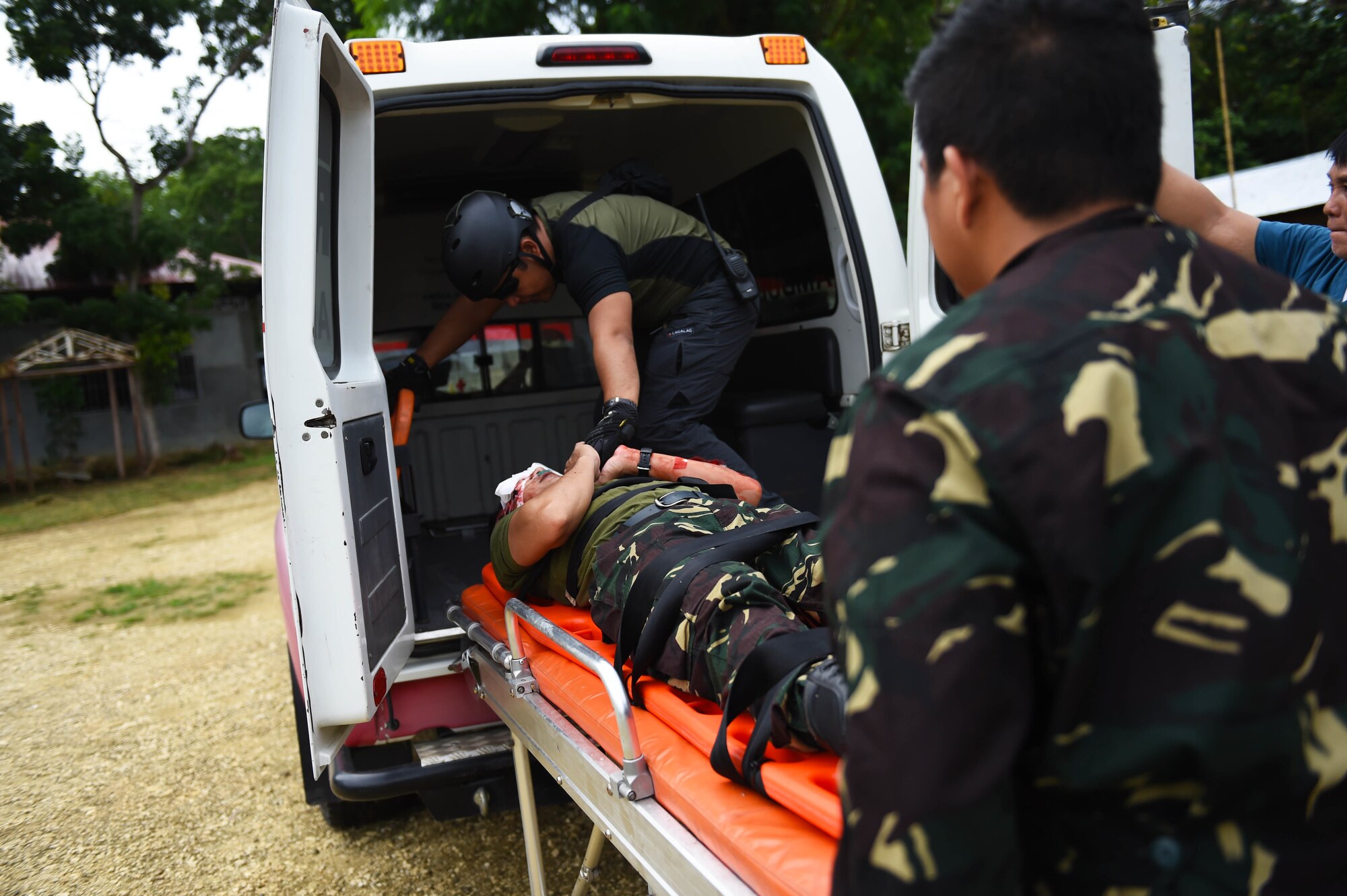 Members of the Philippine army and Telephone and Radio System Integrated Emergency Response load a patient with simulated injuries into an ambulance during a mass casualty exercise pas part of Pacific Angel Philippines, Bohol Province, Philippines, Aug. 21, 2015. A total of 48 first responders from the U.S., Philippines and Philippine non-governmental organizations participated in the mass-casualty exercise. Pacific Angel is a multilateral humanitarian assistance civil military operation, which improves military-to-military partnerships in the Pacific while also providing medical health outreach, civic engineering projects and subject matter exchanges among partner forces. (U.S. Air Force photo by Tech. Sgt. Aaron Oelrich/Released)