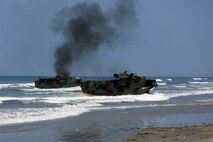 Marines with Headquarters and Service Company, 3d Assault Amphibian Battalion, 1st Marine Division, maneuver their Amphibious Assault Vehicle to the shore aboard Marine Corps Base Camp Pendleton, Calif., after exiting the well deck of amphibious transport dock ship USS New Orleans (LPD18), during a training exercise, Aug. 22, 2015. The purpose of the training was to provide  surf qualification training for the battalion’s crew members. (U.S. Marine Corps photo by Staff Sgt. Bobbie A. Curtis)