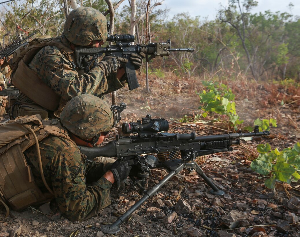 U.S. Marine Corps Cpl. Cody McConnell sights in while U.S. Marine Corps Lance Cpl. Noah Soliz prepares to fire his M240-B medium machine gun during a live-fire squad attack course August 22 during Exercise Crocodile Strike at Mount Bundey Training Area, Northern Territory, Australia. Marines with Marine Rotational Force – Darwin are conducting bilateral training with the Australian Defence Force for two weeks, including dry and live-fire exercises with air and ground elements. The rotational deployment of U.S. Marines affords an unprecedented combined training opportunity with our Australian allies and improves interoperability between our forces. McConnell is a team leader and Soliz is a machine gunner, both with Company C, 1st Battalion, 4th Marine Regiment, MRF-D.