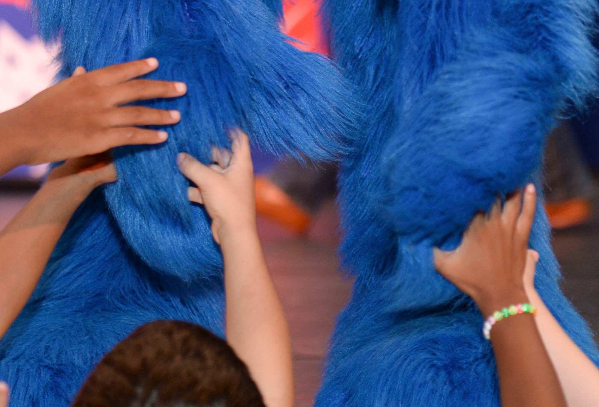 Grover the Muppet shakes hands with children during the United Service Organization Sesame Street presentation at Yokota Air Base, Japan, Aug. 21, 2015. The USO supports military bases around the world with shows that are designed to help families adapt to the unique challenges of military life. (U.S. Air Force photo by Airman 1st Class Elizabeth Baker/Released)