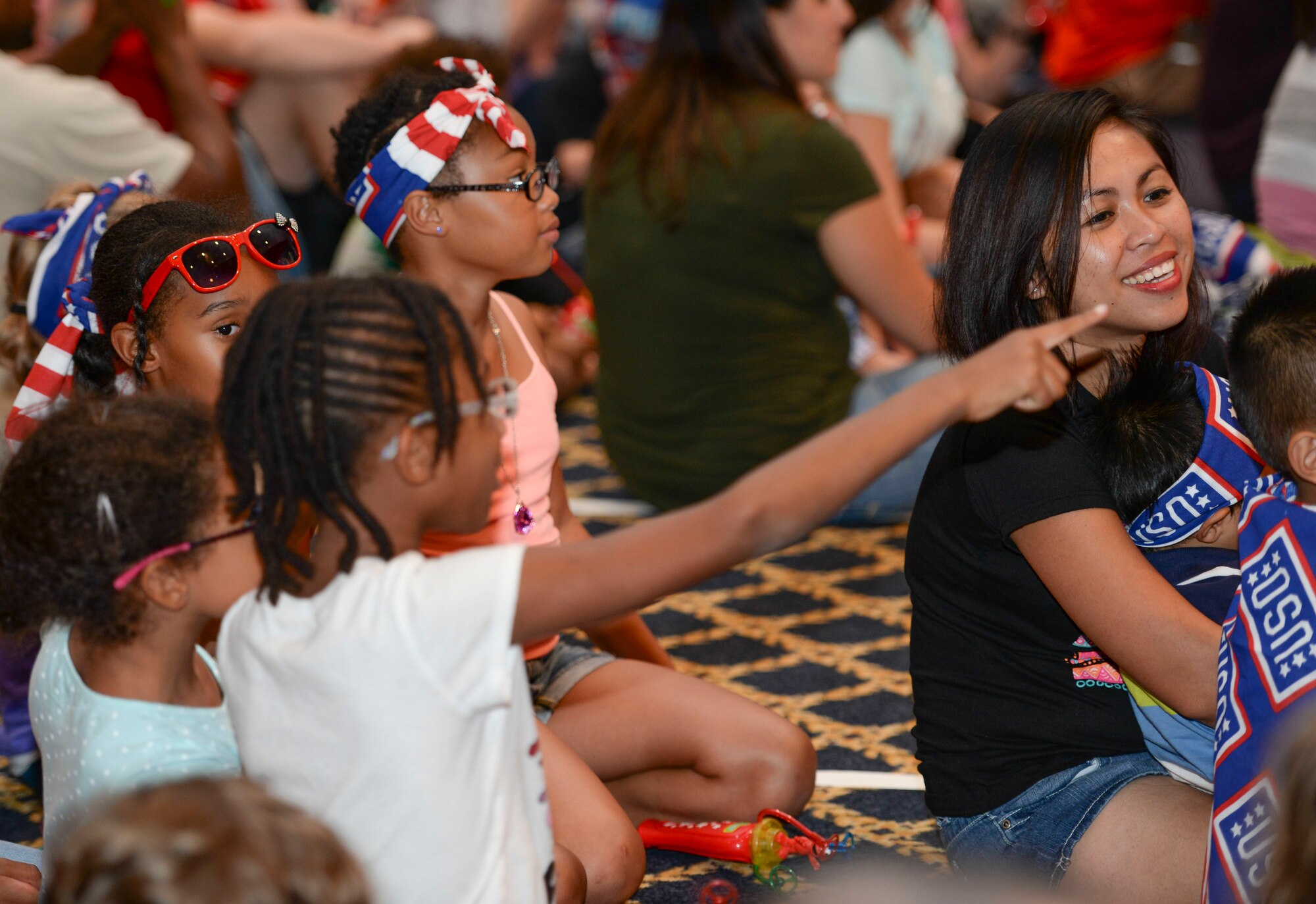 Families watch the United Service Organization Sesame Street presentation at Yokota Air Base, Japan, Aug. 21, 2015. The show was targeted to military children and their parents, giving the children  tips such as how to deal with moving to a new base, and parents talking points to use with their children. (U.S. Air Force photo by Airman 1st Class Elizabeth Baker/Released)