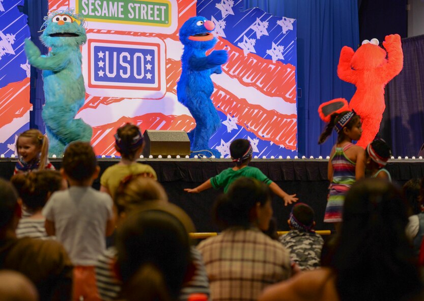 Rosita, Grover, and Elmo perform as children dance during the United Service Organization Sesame Street presentation at Yokota Air Base, Japan, Aug. 21, 2015. The production focused on issues unique to military families, like moving to a new base. (U.S. Air Force photo by Airman 1st Class Elizabeth Baker/Released)