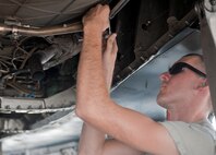 Senior Airman Shawn Lawson, 757th Aircraft Maintenance Squadron Strike Aircraft Maintenance Unit engine specialist, installs a flex strap on an F-15E Strike Eagle on the flightline at Nellis Air Force Base, Nev., Aug. 19, 2015. Strike AMU has approximately 170 Airmen working on 16 Strike Eagles. (U.S. Air Force photo by Airman 1st Class Mikaley Towle)