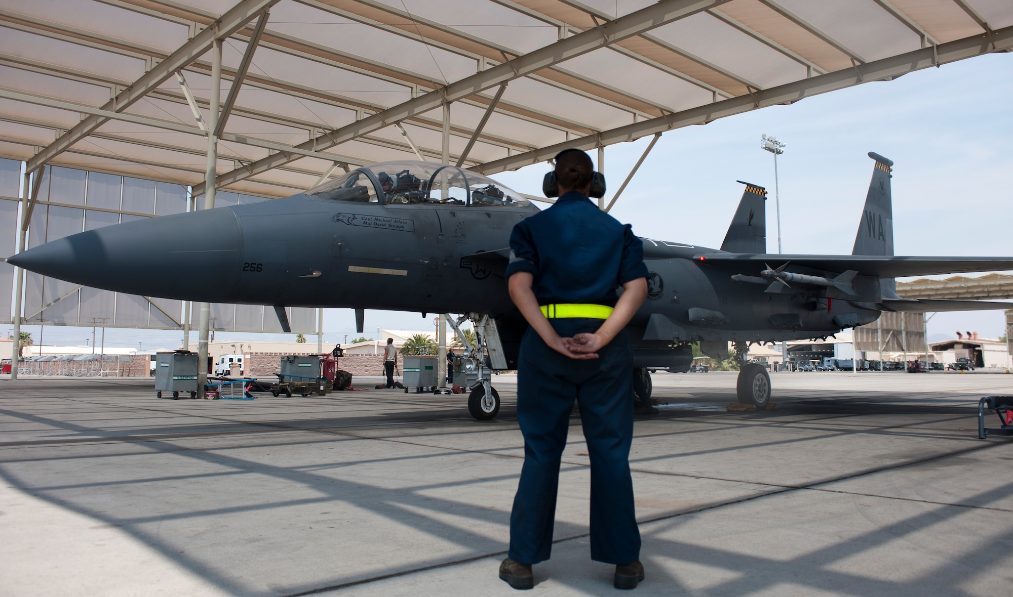 Airman 1st Class Diana Boroski, 757th Aircraft Maintenance Squadron Strike Aircraft Maintenance Unit maintainer, recovers an F-15E Strike Eagle on the flightline at Nellis Air Force Base, Nev., Aug. 19, 2015. Strike AMU supports the 17th Weapons Squadron as well as the 422nd Test and Evaluation Squadron. (U.S. Air Force photo by Airman 1st Class Mikaley Towle)