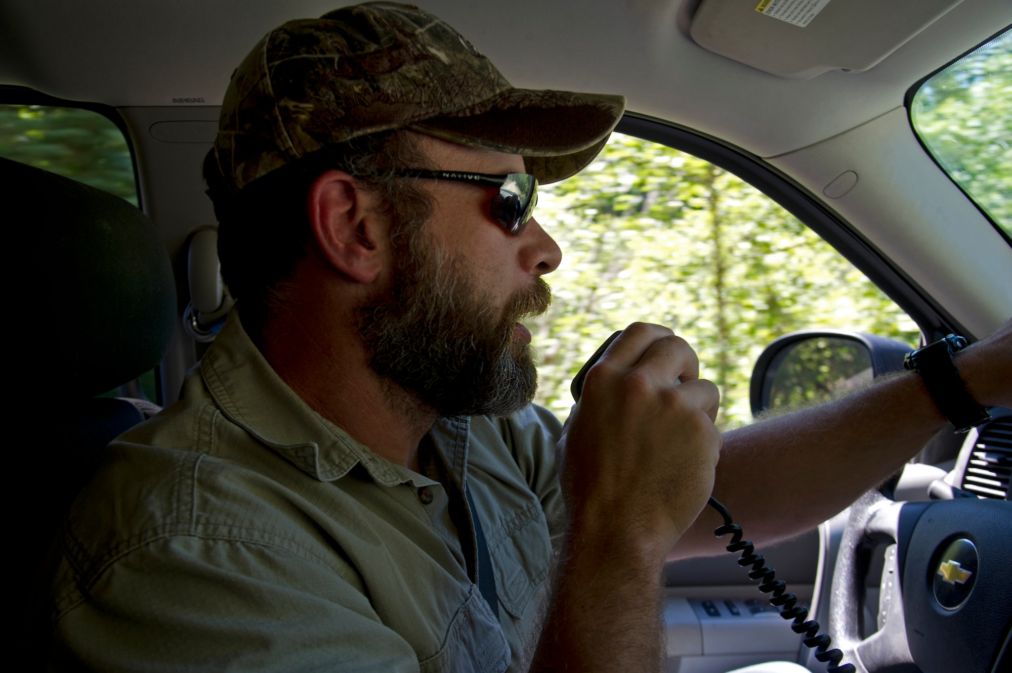 Todd Foster, 336th Training Group training area manager, speaks on the radio July 29, 2015, at Colville National Forest, Wash. Foster and others are required to ‘call up’ the roads before traversing the area to prevent mishaps from occurring. (U.S. Air Force photo/Airman 1st Class Nicolo J. Daniello)