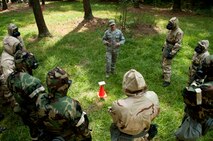 Senior Airman Timothy Roberts, 4th Civil Engineer Squadron emergency management personnel, explains proper use of simulated chemical detection paper during an Ability to Survive and Operate (ATSO) exercise, Aug. 25, 2015, at Seymour Johnson Air Force Base, North Carolina. Roberts instructed the Airmen to conduct a mock post-attack reconnaissance and identify the various chemical agents that could be detected on the paper. (U.S. Air Force photo/Master Sgt. Jocelyn L. Rich-Pendracki)