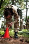 Airman 1st Class Corey Krebs, 4th Logistic Readiness Squadron vehicle maintainer, places simulated chemical detection paper on a stanchion for an Ability to Survive and Operate (ATSO) exercise, Aug. 25, 2015, at Seymour Johnson Air Force Base, North Carolina. As part of the ATSO exercise, Airmen were required to don mission-oriented protective posture gear and perform a mock post-attack reconnaissance sweep where they checked for different types of “contamination”. (U.S. Air Force photo/Master Sgt. Jocelyn L.  Rich-Pendracki)