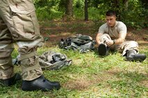 Airman 1st Class Colton Brouse, 4th Operations Support Squadron intelligence operation specialist, dons mission-oriented protective posture gear for an Ability to Survive and Operate (ATSO) exercise, Aug. 25, 2015, at Seymour Johnson Air Force Base, North Carolina. During the ATSO rodeo, Airmen outfitted the various phases of MOPP gear and performed a mock post-attack reconnaissance sweep. (U.S. Air Force photo/Master Sgt. Jocelyn L. Rich-Pendracki)