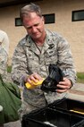 Col. Mark Slocum, 4th Fighter Wing commander, cleans out a gas mask after participating in an Ability to Survive and Operate (ATSO) exercise, Aug. 25, 2015, at Seymour Johnson Air Force Base, North Carolina. Slocum wore mission-oriented protective posture gear and participated alongside other Airmen during the ATSO rodeo. (U.S. Air Force photo/Airman Shawna L. Keyes) 