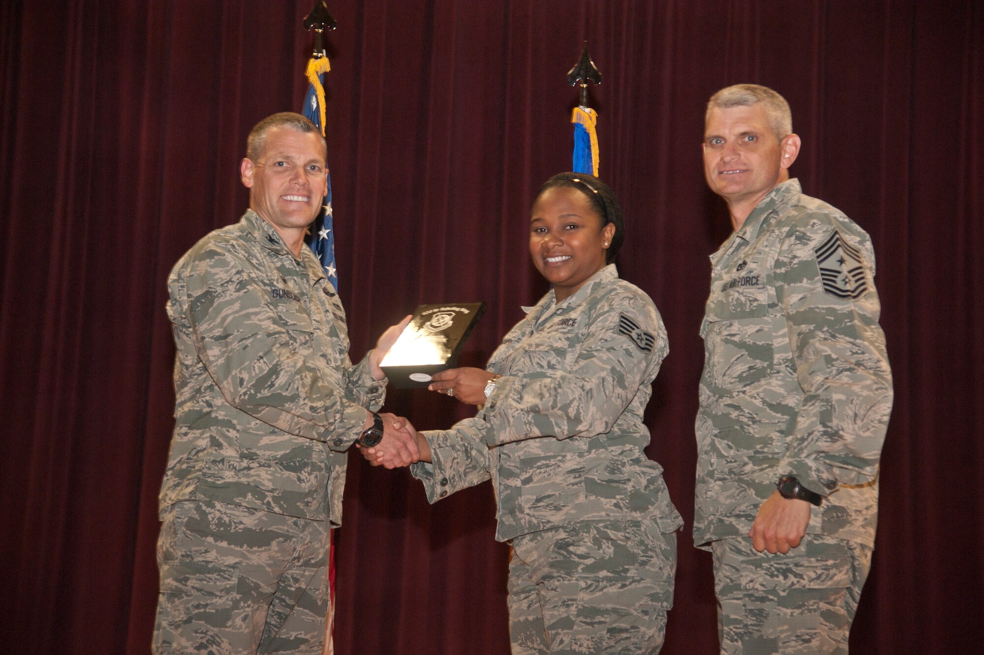 Staff Sgt. Jasmine Phillips, 92nd Aerospace Medicine Squadron NCO in charge of infection control, accepts the 92nd Air Refueling Wing Volunteer of the Quarter award Aug. 24, 2015, at Fairchild Air Force Base, Wash. (U.S. Air Force photo/Airman 1st Class Taylor Bourgeous)