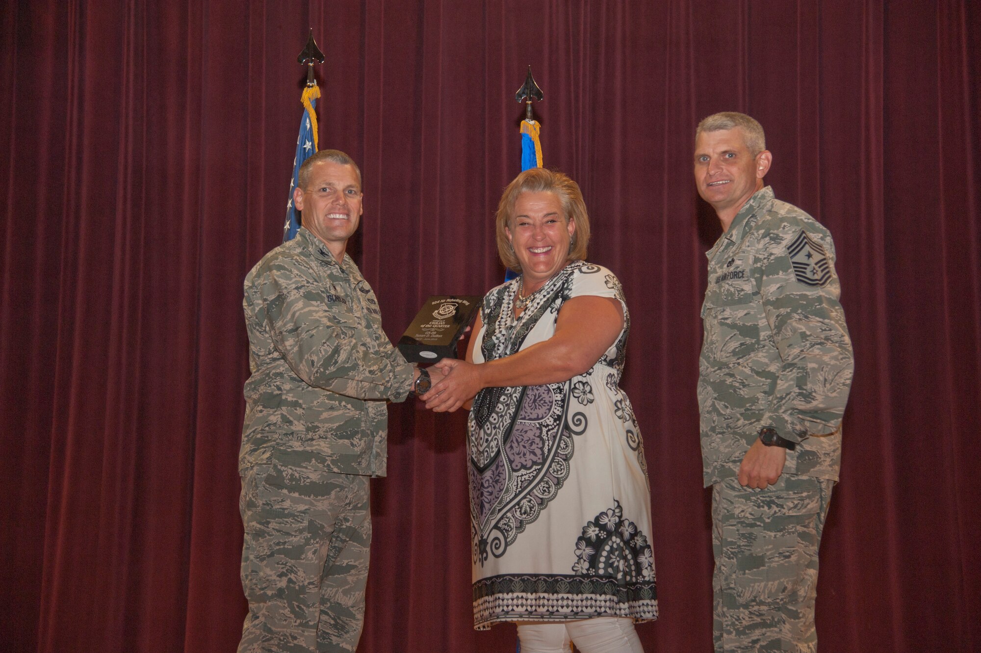 Susan Dalton, 92nd Contracting Squadron contract specialist, accepts the 92nd Air Refueling Wing Category Two Civilian of the Quarter award Aug. 24, 2015, at Fairchild Air Force Base, Wash. (U.S. Air Force photo/Airman 1st Class Taylor Bourgeous) 