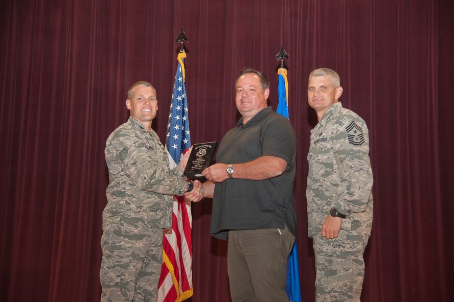 Joseph Luft, 92nd Air Refueling Squadron unit program coordinator, accepts the 92nd Air Refueling Wing Category One Civilian of the Quarter award Aug. 24, 2015, at Fairchild Air Force Base, Wash. (U.S. Air Force photo/Airman 1st Class Taylor Bourgeous)