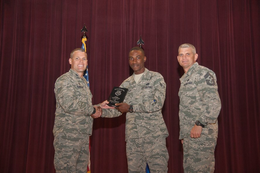 Airman 1st Class Adeola Adeboyejo, 92nd Force Support Squadron career development technician, receives the 92nd Air Refueling Wing Airman of the Quarter award Aug. 24, 2015, at Fairchild Air Force Base, Wash. (U.S. Air Force photo/Airman 1st Class Taylor Bourgeous)