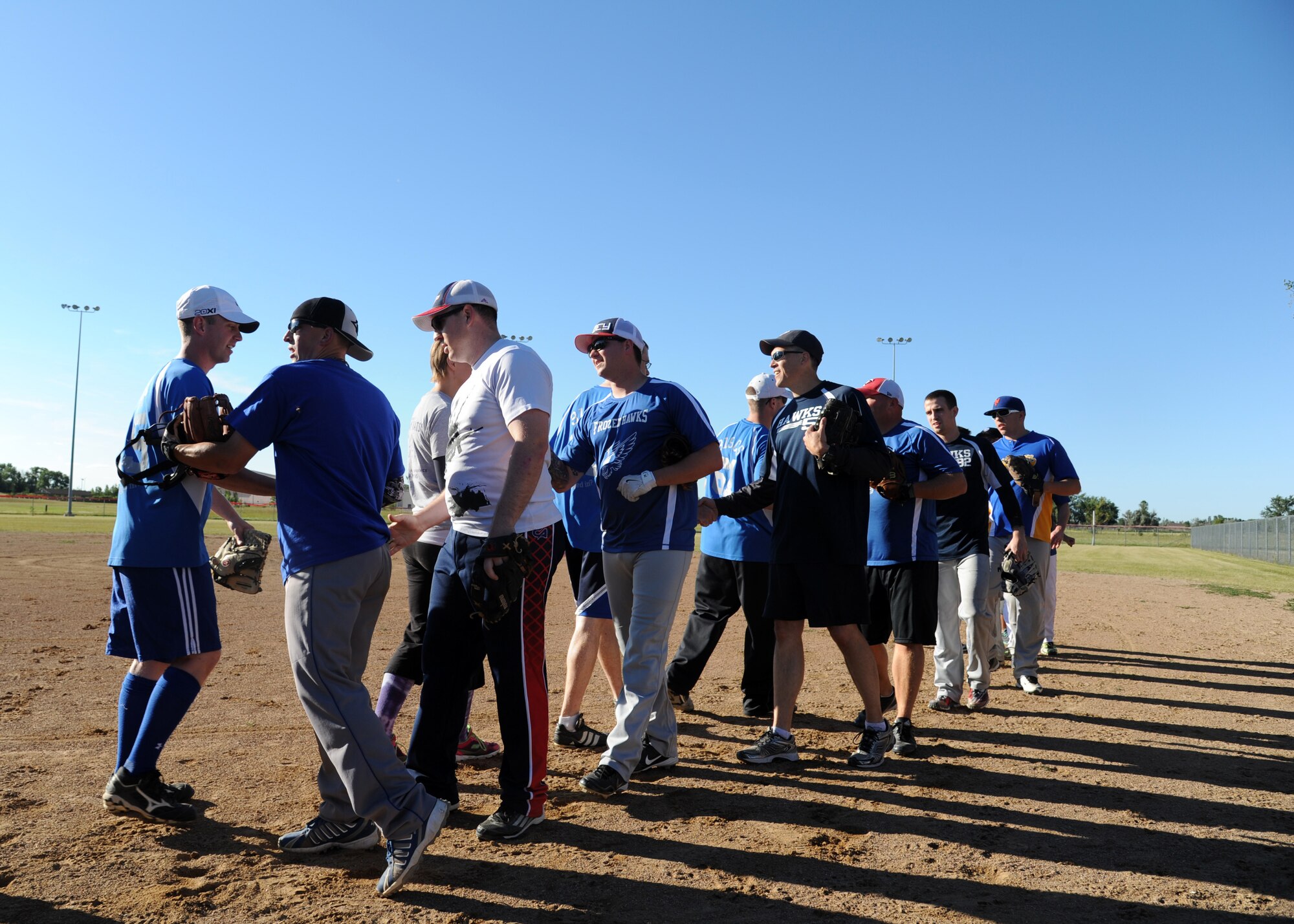 Airmen from the 319th Communications Squadron and 69th Reconnaissance Group shake hands after the Intramural Softball Championship game August 24, 2015, on Grand Forks Air Force Base, North Dakota. The 69th RG defeated the 319th CS by a score of four to one to conclude the 2015 softball season. (U.S. Air Force photo by Airman 1st Class Ryan Sparks/Released)