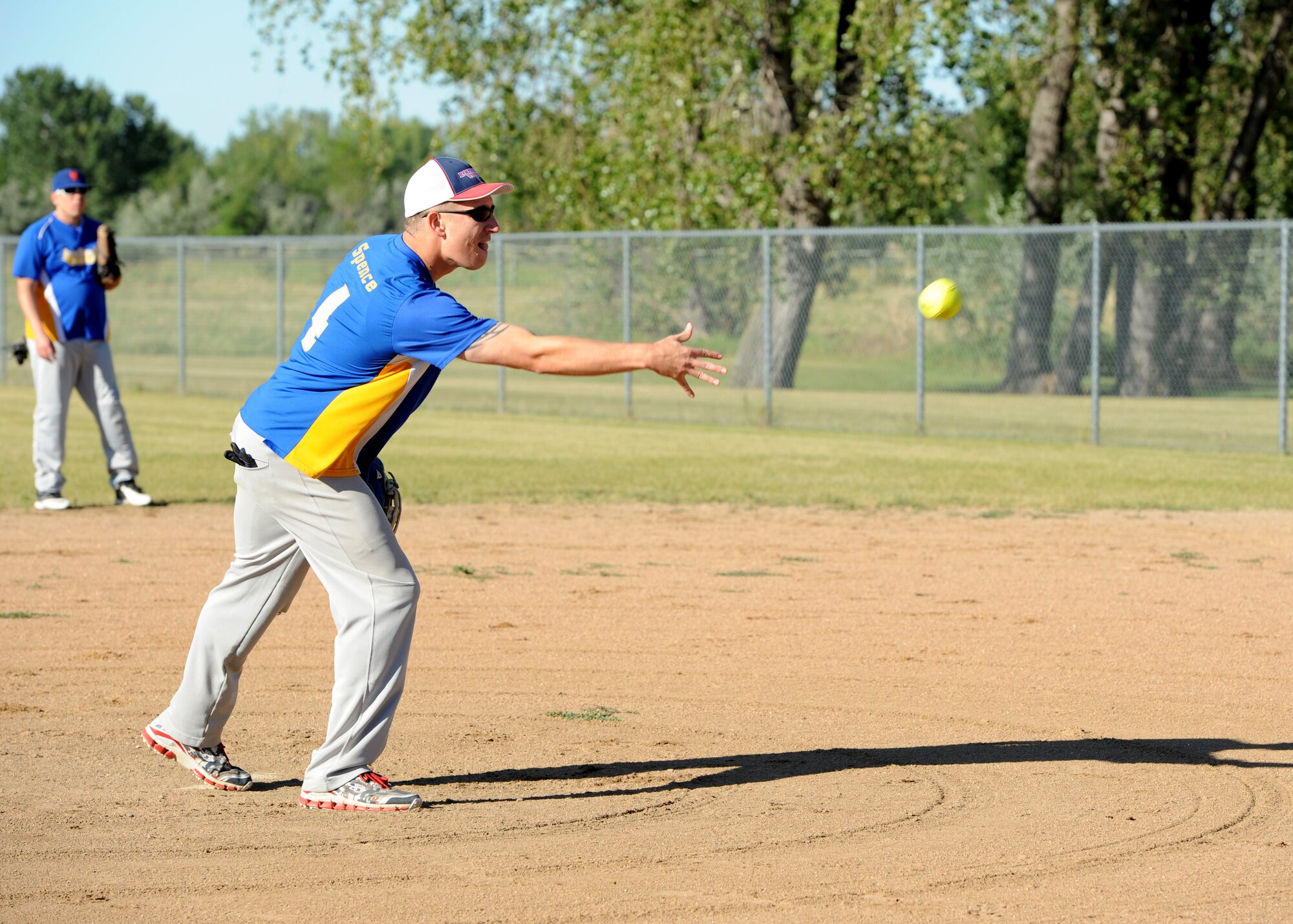 Staff Sgt. Thomas Spencer, 69th Maintenance Squadron debrief NCO-in-charge, pitches the ball August 24, 2015, on Grand Forks Air Force Base, North Dakota. Thomas was a member of the 69th Reconnaissance Group team who won the championship game. (U.S. Air Force photo by Airman 1st Class Ryan Sparks/Released)