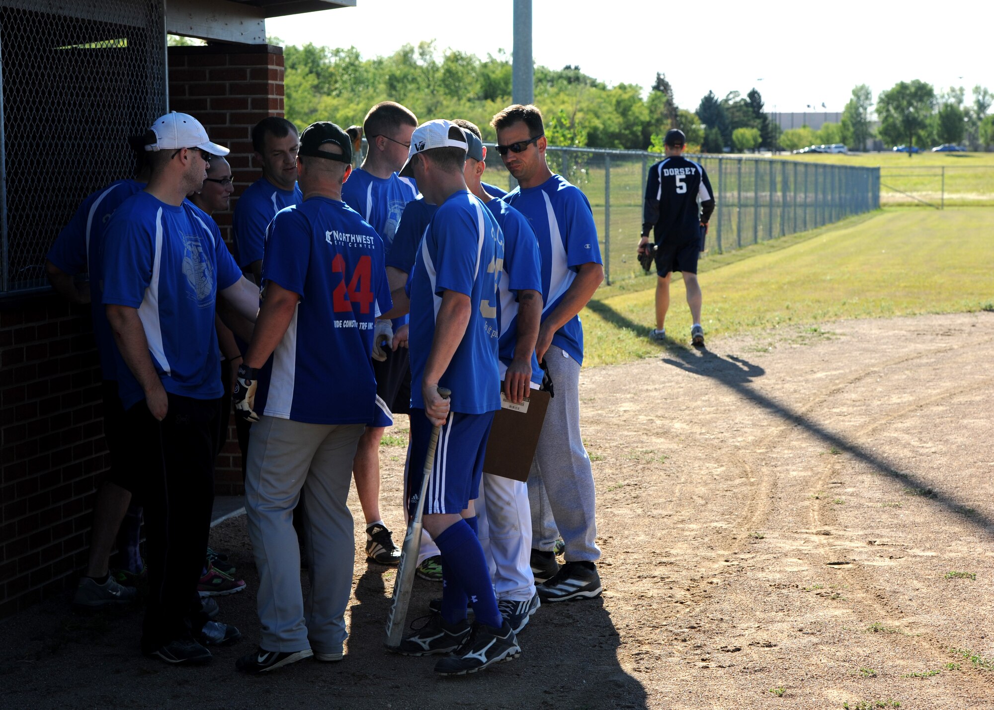 Airmen from the 319th Communications Squadron huddle together before the Intramural Softball Championship game August 24, 2015, on Grand Forks Air Force Base, North Dakota. The 319th CS lost to the 69th Reconnaissance Group by a score of four to one. (U.S. Air Force photo by Airman 1st Class Ryan Sparks/Released)
