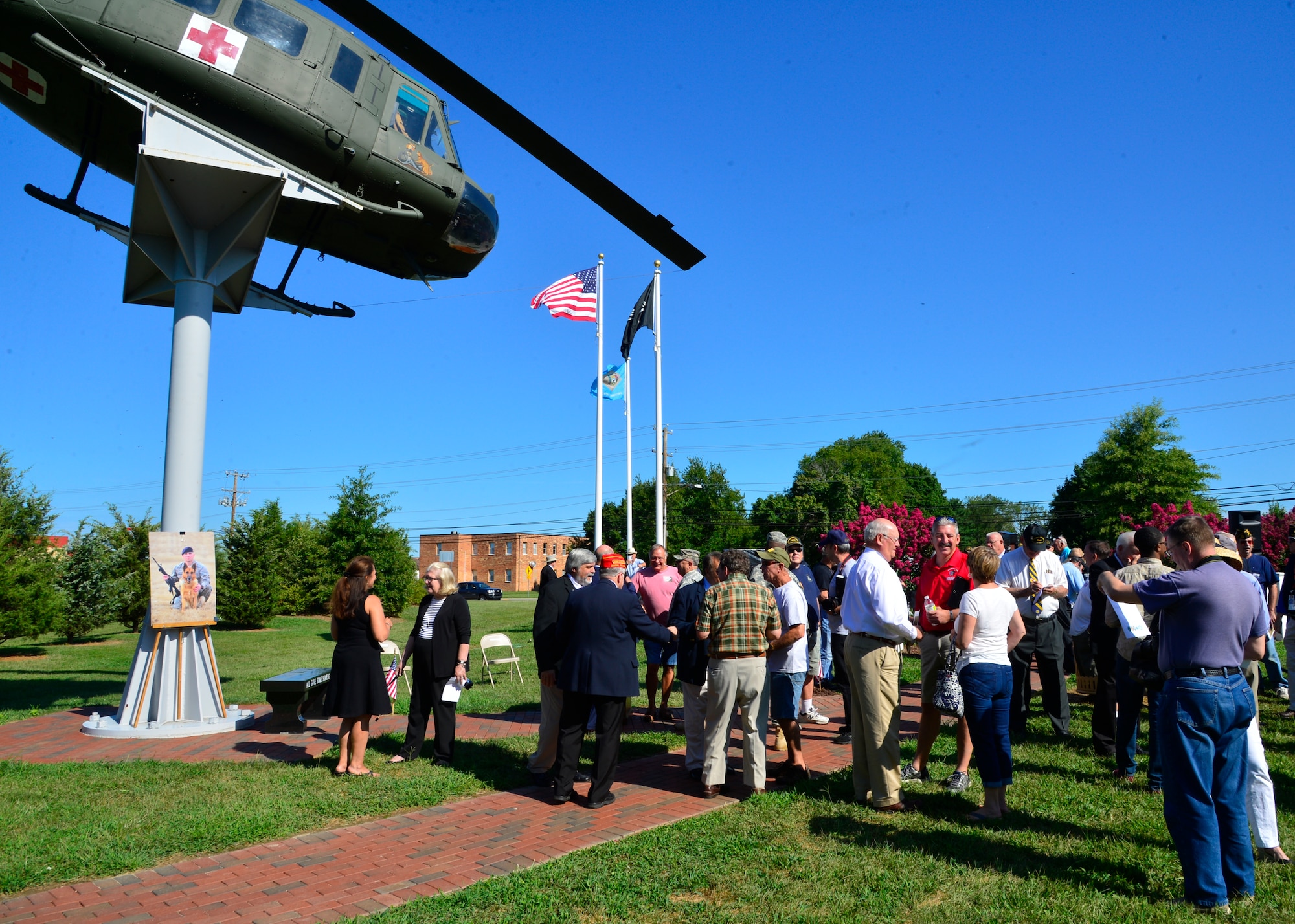 Attendees of the War Dog Memorial Dedication socialize before the start of the event Aug. 22, 2015, at the Kent County Veterans Memorial Park in Dover, Del. More than 100 people attended the unveiling of Delaware’s first War Dog Memorial.  (U.S. Air Force photo/Airman 1st Class William Johnson)