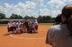 U.S. Air Force Col. Thomas Kunkel, 23d Wing commander, and his family pose for a picture with the Lowndes High School Vikettes after throwing out the first pitch at a military appreciation softball game at Morris-Coats Field of Dreams, Valdosta, Ga., Aug. 22, 2015. Events like these help build the relationship between the local community and Moody Air Force Base. (U.S. Air Force photo by Andrea Jenkins/Released).