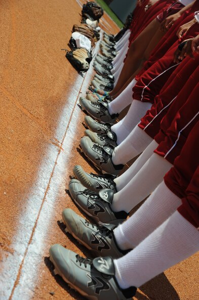 Lowndes High School Vikettes softball players stand on the third base line during team introductions at the Lowndes High School Vikettes Military Appreciation softball game at Morris-Coats Field of Dreams, Valdosta, Ga., Aug. 22, 2015. The team invited the 23d Wing commander and his family to throw out the first pitch to show their appreciation for the military. (U.S. Air Force photo by Andrea Jenkins/Released)