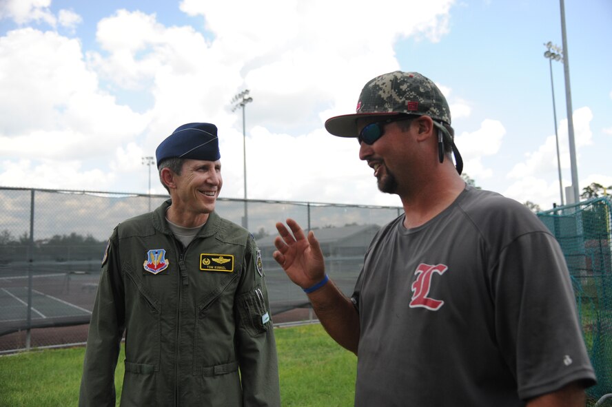 Lowndes High School Vikettes softball team coach, Stewart Thomas (right), talks to U.S. Air Force Col. Thomas Kunkel, 23d Wing commander, at the Lowndes High School Vikettes Military Appreciation softball game at Morris-Coats Field of Dreams, Valdosta, Ga., Aug. 22, 2015. Moody Air Force Base continues to build on its enduring relationship with the local community through events like these. (U.S. Air Force photo by Andrea Jenkins/Released).