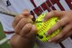 A softball player signs the game ball during the Lowndes High School Vikettes Military Appreciation softball game at Morris-Coats Field of Dreams, Valdosta, Ga., Aug. 22, 2015. The Vikettes softball team and coaches signed a ball and presented it to the Kunkel Family as a token of their appreciation. (U.S. Air Force photo by Andrea Jenkins/Released)