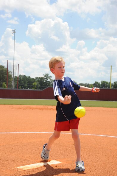 Noah Kunkel, son of U.S. Air Force Col. Thomas Kunkel, 23d Wing commander, throws the first pitch at the Lowndes High School Vikettes Military Appreciation softball game at Morris-Coats Field of Dreams, Valdosta, Ga., Aug. 22, 2015. This was one of the first community events that allowed the Kunkel family to interact with local members of the community. (U.S. Air Force photo by Andrea Jenkins/Released).