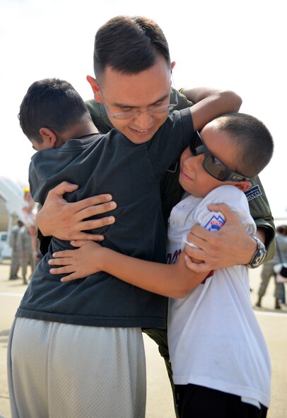 Maj. Joe Foster, 20th Bomb Squadron assistant director of operations, is greeted by his sons upon returning from a six-month deployment to Guam, at Barksdale Air Force Base, La., Aug. 24, 2015. The U.S. military has maintained a deployed strategic bomber presence in the Indo-Asia-Pacific region since March 2004, which has contributed significantly to regional security and stability. (U.S. Air Force photo/Airman 1st Class Mozer O. Da Cunha)