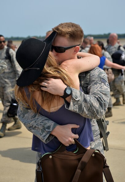 An Airman is greeted by a loved one at Barksdale Air Force Base, La., Aug. 24, 2015. Continuous Bomber Presence deployments provide opportunities to advance and strengthen alliances as well as strengthen long-standing, military-to-military partnerships. (U.S. Air Force photo/Airman 1st Class Mozer O. Da Cunha)	