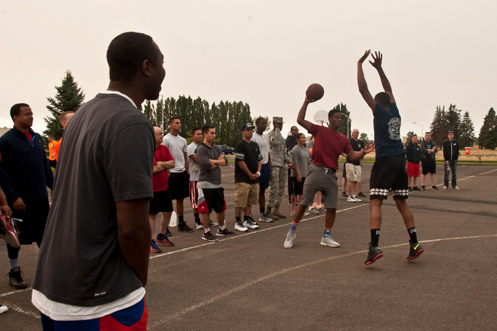 Members of the 92nd Force Support Squadron compete against members of the 92nd Medical Group in the finals during a three-on-three basketball tournament Aug. 20, 2015, at Fairchild Air Force Base, Wash. The basketball tournament was just one of the many activities available to Airmen on a day designed to improve wing morale and readiness. The 92nd Maintenance Group won the competition overall bringing home the coveted silver trophy. (U.S. Air Force photo/ Airman 1st Class Mackenzie Richardson)