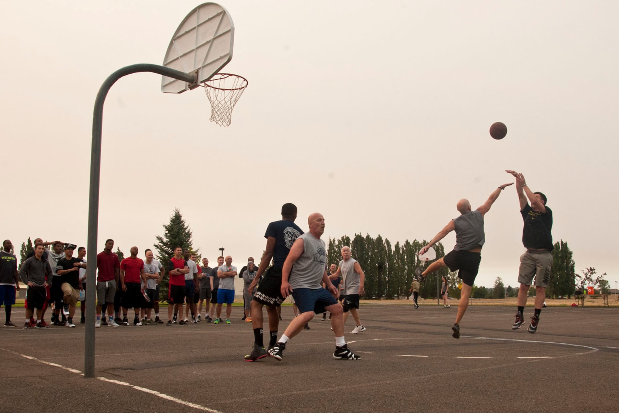 Members of the 92nd Medical Group compete against members of 92nd Civil Engineer Squadron in a three-on-three basketball tournament during Summer Sports Day Aug. 20, 2015, at Fairchild Air Force Base, Wash. The tournament consisted of 12 teams competing for the Summer Sports Day Trophy. (U.S. Air Force photo/Airman 1st Class Mackenzie Richardson)