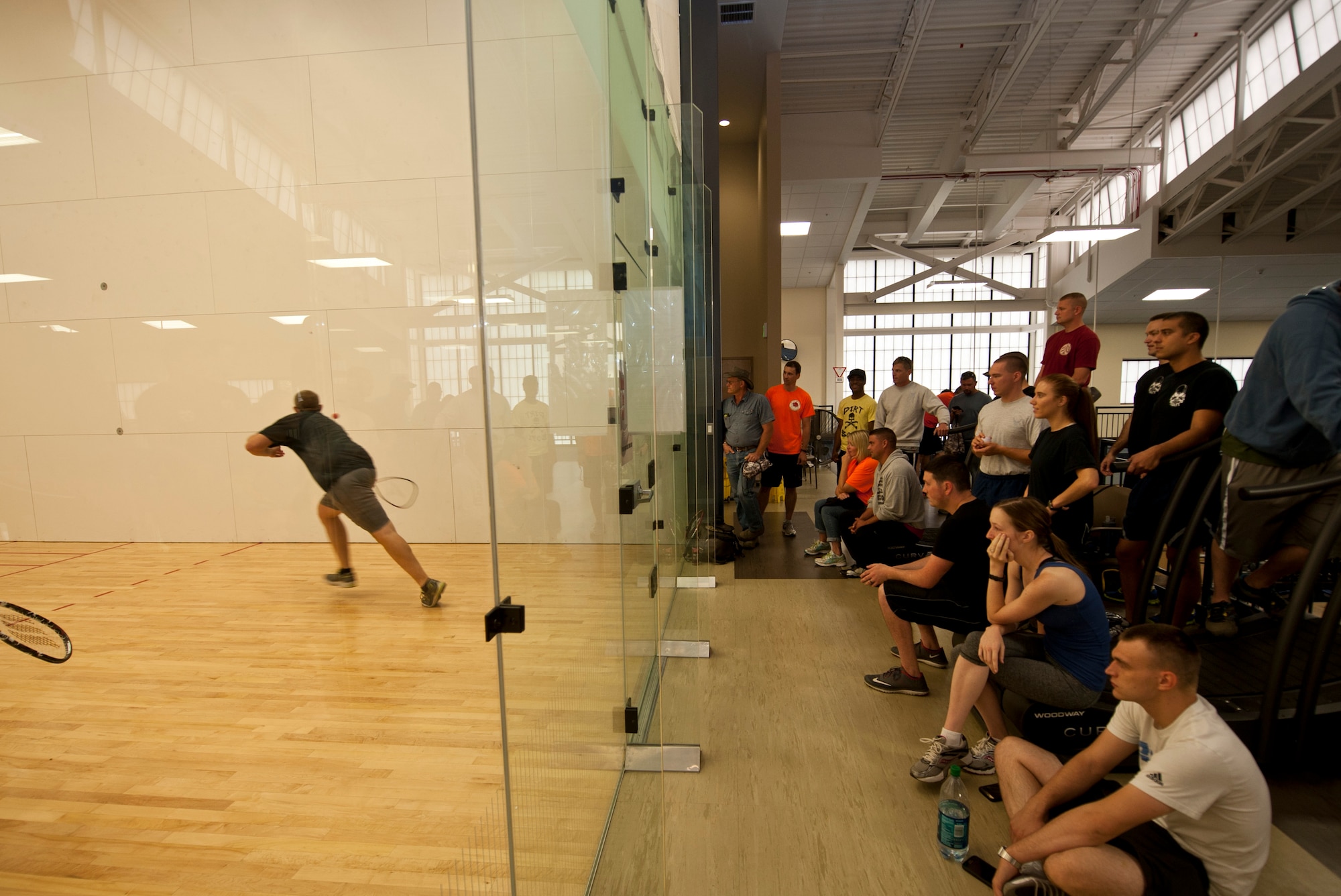 The crowd watches Ted Strom, 92nd Civil Engineer Squadron Snow Barn foreman, goes after the ball during a game of racquetball Aug. 20, 2015, at Fairchild Air Force Base, Wash. The outcome of the racquetball tournament ended with the 92nd Security Forces Squadron team coming in first place. (U.S. Air Force Photo/Airman Sean Campbell)