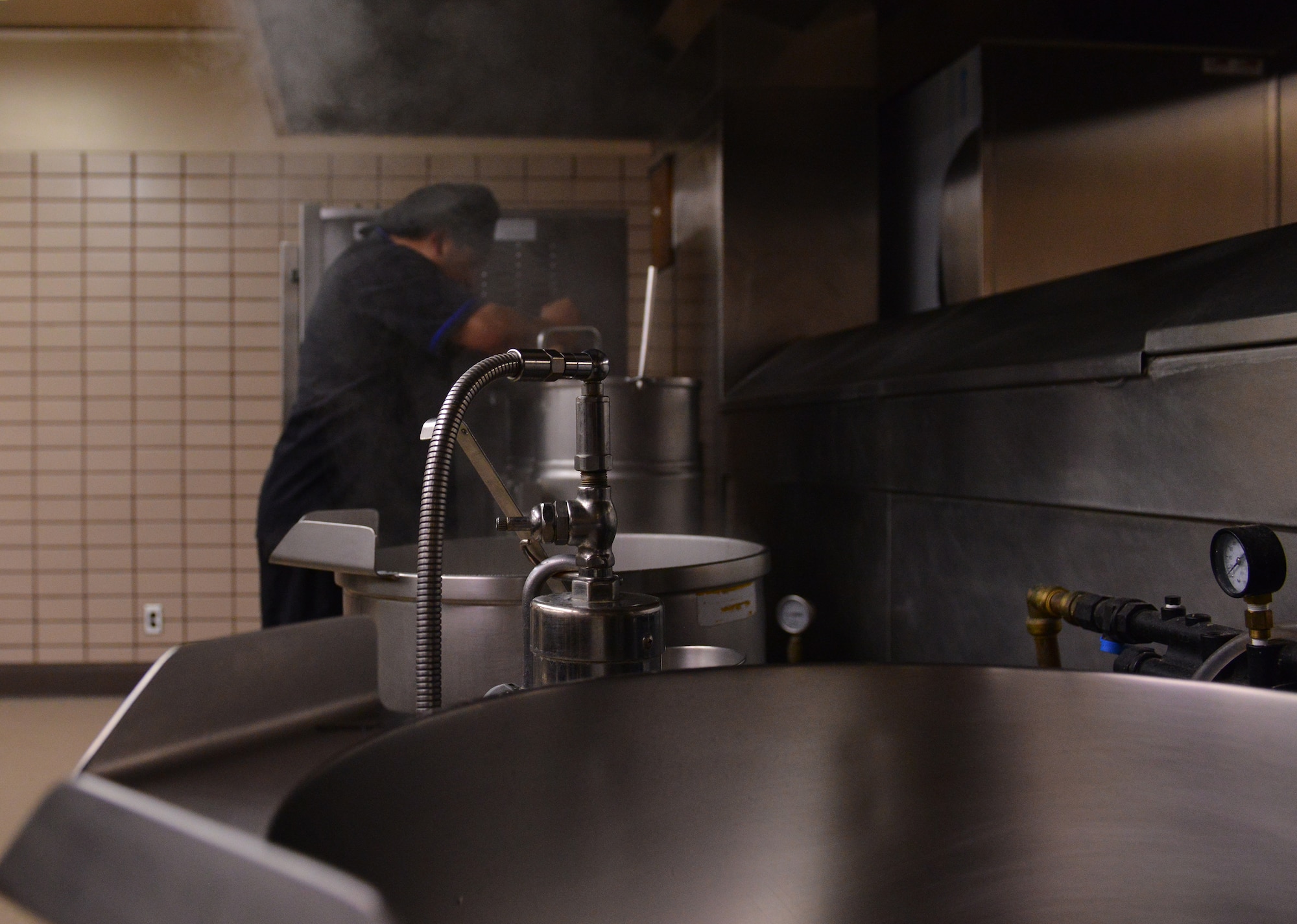 U.S. Navy Culinary Specialist 2nd Class Daniel Gleeson with Electronic Attack Squadron 209 out of Naval Air Station Whidbey Island, Wash., prepares food for the dinner rush Aug. 18, 2015, during RED FLAG-Alaska (RF-A) 15-3 at the Two Seasons Dining Facility on Eielson Air Force Base, Alaska. During RF-A, the facility dishes out more than 1,400 meals per day, three times its normal support rate of 300 to 400 meals. (U.S. Air Force photo by Airman 1st Class Kyle Johnson/Released)
