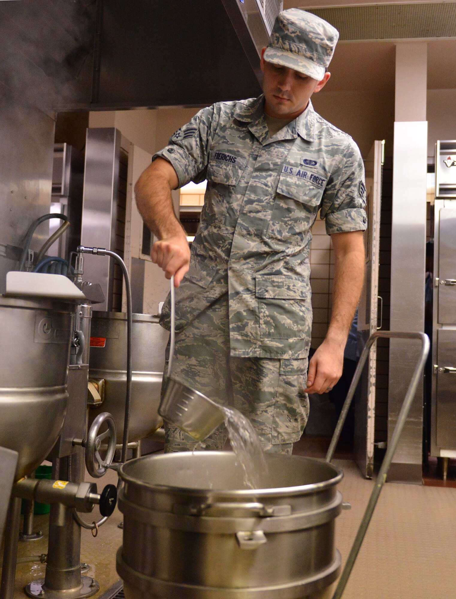 U.S. Air Force Senior Airman Christopher Frerichs, a 354th Force Support Squadron food services journeyman, prepares hot water to be used for mashed potatoes Aug. 18, 2015, during RED FLAG-Alaska (RF-A) 15-3 at the Two Seasons Dining Facility on Eielson Air Force Base, Alaska. During RF-A, the facility dishes out more than 1,400 meals per day, three times its normal support rate of 300 to 400 meals. (U.S. Air Force photo by Airman 1st Class Kyle Johnson/Released)