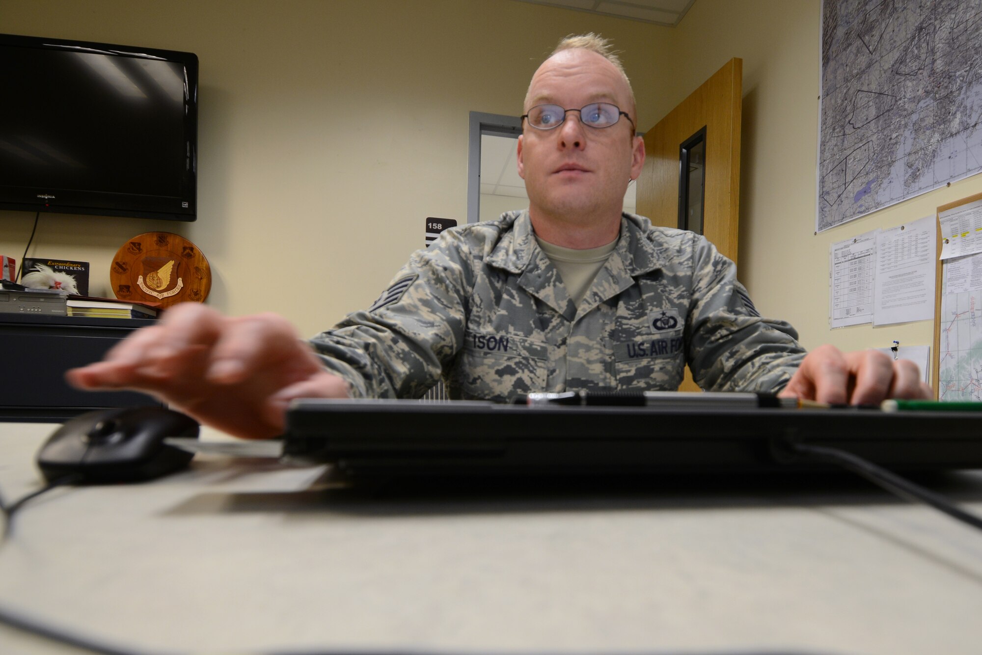 U.S. Air Force Staff Sgt. Matthew Ison, the 354th Operations Support Squadron noncommissioned officer in-charge of current operations, sends out a schedule Aug. 19, 2015, at Eielson Air Force Base, Alaska. Ison prepares airspace route schedules every day, which allow for the most effective training from each participating unit. (U.S. Air Force photo by Senior Airman Ashley Nicole Taylor/Released)