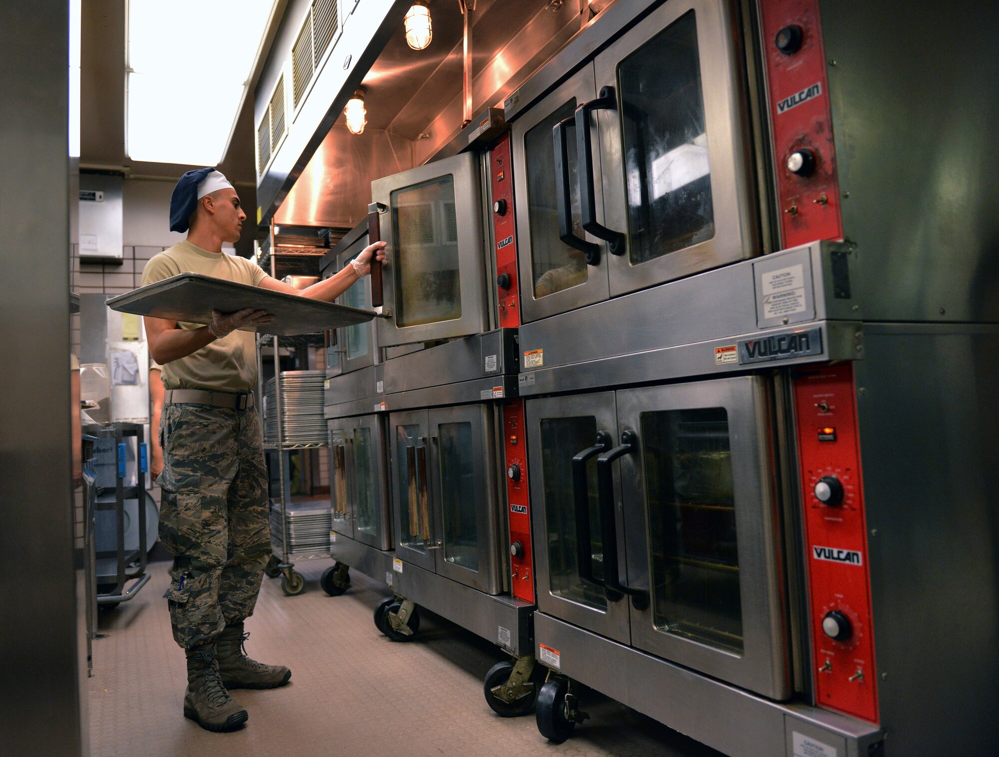 U.S. Air Force Airman 1st Class Tyler Morgan, a 354th Force Support Squadron food services apprentice, prepares food for the dinner rush Aug. 18, 2015, during RED FLAG-Alaska (RF-A) 15-3 at the Two Seasons Dining Facility on Eielson Air Force Base, Alaska. During RF-A, the facility dishes out more than 1,400 meals per day, three times its normal support rate of 300 to 400 meals. (U.S. Air Force photo by Airman 1st Class Kyle Johnson/Released)