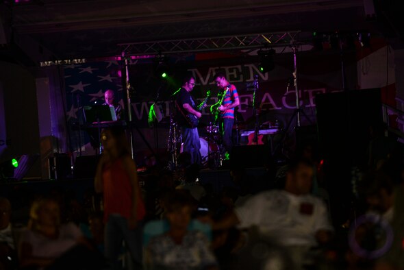 The band “Men with Faces” plays music for the crowd during the Independence Day Celebration and Back to School Bash, Aug. 21, 2015, at Seymour Johnson Air Force Base, North Carolina. The bash featured multiple food vendors and boutiques and ended with fireworks at the end of the night. (U.S. Air Force photo/Airman 1st Class Ashley Williamson)