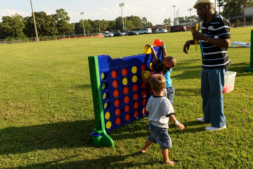 Members of Team Seymour play Connect Four during the Independence Day Celebration and Back to School Bash, Aug. 21, 2015, at Seymour Johnson Air Force Base, North Carolina. The event was open to all DOD ID card holders and featured various activities and food for all attendees. (U.S. Air Force photo/Airman 1st Class Ashley Williamson)