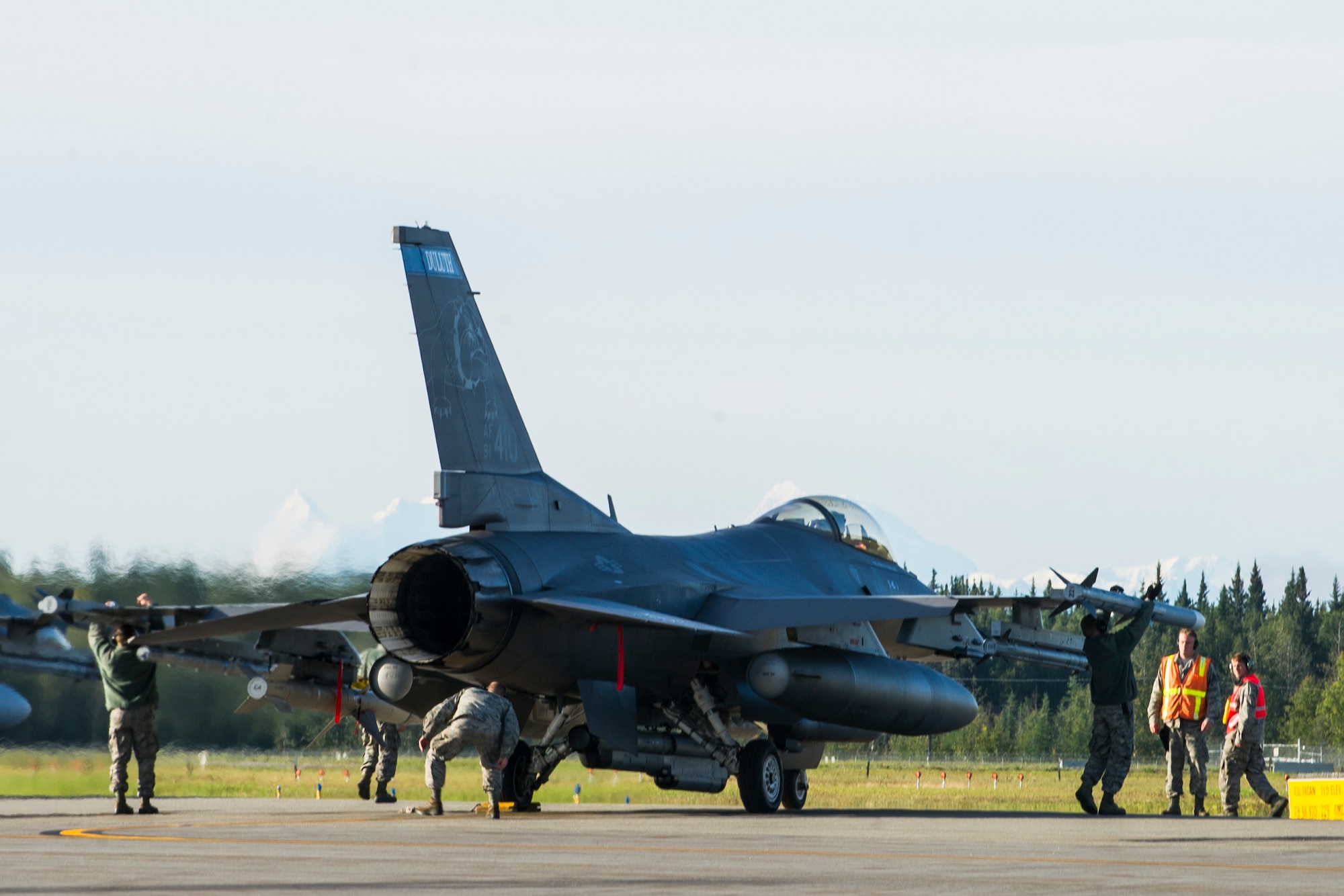 U.S. Air Force weapons load Airmen assigned to the Minnesota Air National Guard’s 148th Fighter Wing out of Duluth, Minn., perform final inspections before take-off on an F-16 Fighting Falcon at Eielson Air Force Base, Alaska, Aug. 21, 2015, during RED FLAG-Alaska (RF-A) 15-3. RF-A is a series of Pacific Air Forces commander-directed field training exercise for U.S. and partner nation forces, providing combined offensive counter-air, interdiction, close air support and large force employment training in a simulated combat environment. (U.S. Air Force photo by Staff Sgt. Joshua Turner/Released)