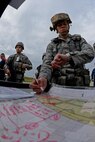 U.S. Air Force Tech. Sgt. Rebecca James, 100th Security Forces Squadron flight chief, annotates the time during an exercise Aug. 24, 2015 on RAF Mildenhall, England. Emergency responders worked together to form and carry out a plan of action to recover a KC-135 Stratotanker that was taken by Airmen posing as hijackers. (U.S. Air Force photo by Staff Sgt. Micaiah Anthony/Released)