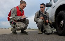 U.S. Air Force Tech. Sgt. Sarah Aguilar, 100th Security Forces Squadron exercise evaluator, asks U.S. Air Force Staff Sgt. Peter Simonelli, 100th SFS response force leader, a few questions during an exercise Aug. 24, 2015, on RAF Mildenhall, England. Exercises are conducted to test and train Airmen on how to handle certain situations. (U.S. Air Force photo by Staff Sgt. Micaiah Anthony/Released)