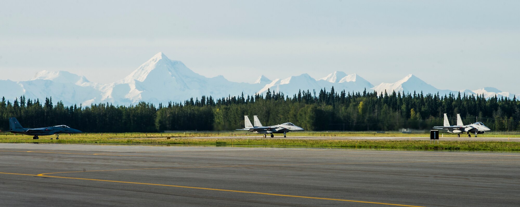 Three Japan Air Self-Defense Force (JASDF) F-15J Eagles prepare to take off from Eielson Air Force Base, Alaska, Aug. 21, 2015, during RED FLAG-Alaska (RF-A) 15-3. JASDF and Republic of Korea Air Force units deployed to Eielson along with assorted aircraft and support personnel from multiple service branches for RF-A, a series of Pacific Air Forces commander-directed field training exercise for U.S. and partner nation forces, providing combined offensive counter-air, interdiction, close air support, and large force employment training in a simulated combat environment. (U.S. Air Force photo by Staff Sgt. Joshua Turner/Released)