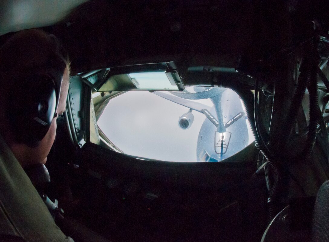 U.S. Air Force Staff Sgt. Tyson Krug, a boom operator with the 128th Air Refueling Wing, Wisconsin Air National Guard, operates a KC-135R Stratotanker’s boom for an aerial refueling July 7, 2015. The KC-135’s mission was to perform an aerial refueling on the AR-128 East and West Refueling Route in support of U.S. military deploying aircraft. (U.S. Air National Guard photo by Airman 1st Class Morgan R. Lipinski/Released)