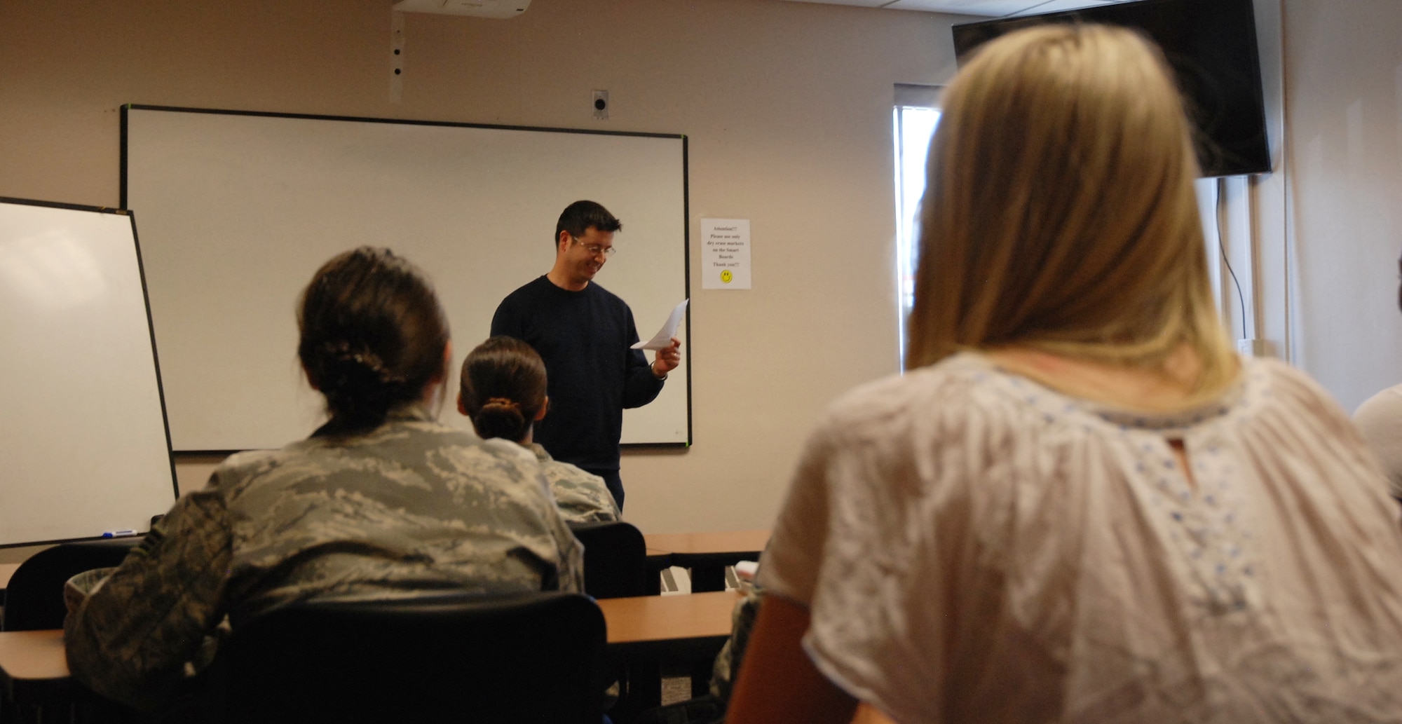 PETERSON AIR FORCE BASE, Colo. - Tech. Sgt. Shahn Christensen, 310th Security Forces Squadron, presents a mock award ceremony to classmates during a speech and public speaking class offered at Peterson Air Force Base through Pikes Peak Community College. Christensen is working toward a degree to enhance his business pursuits. (U.S. Air Force photo by Dave Smith)