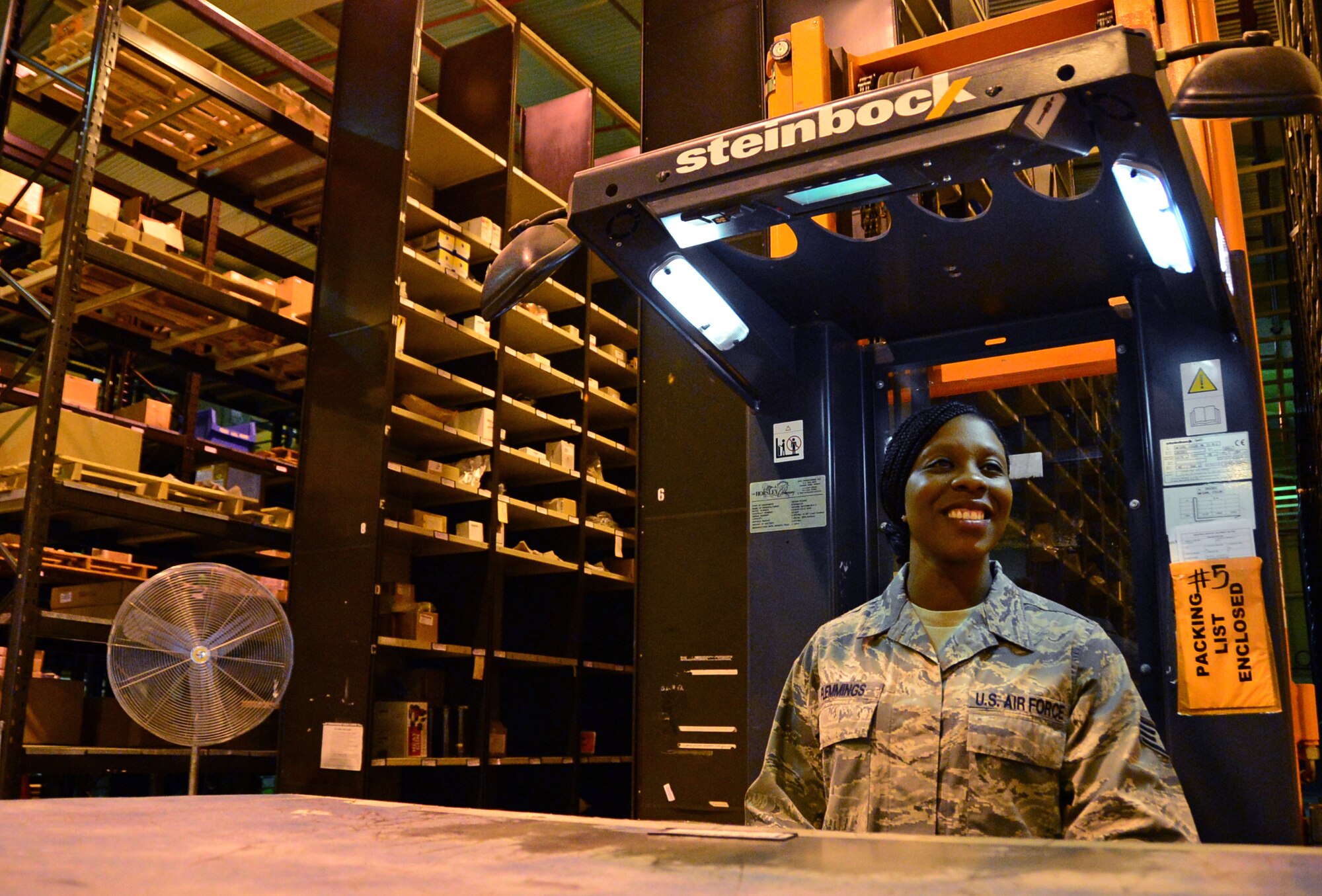 Staff Sgt. Tychelle Flemmings, 48th Logistics Readiness Squadron central storage supervisor, operates a cherry picker in a warehouse at Royal Air Force Lakenheath, England, July 22, 2015. Flemmings was nominated for a Liberty Spotlight because she embodies the core value of Excellence in All We Do. (U.S. Air Force photo by Senior Airman Erin O’Shea/Released) 